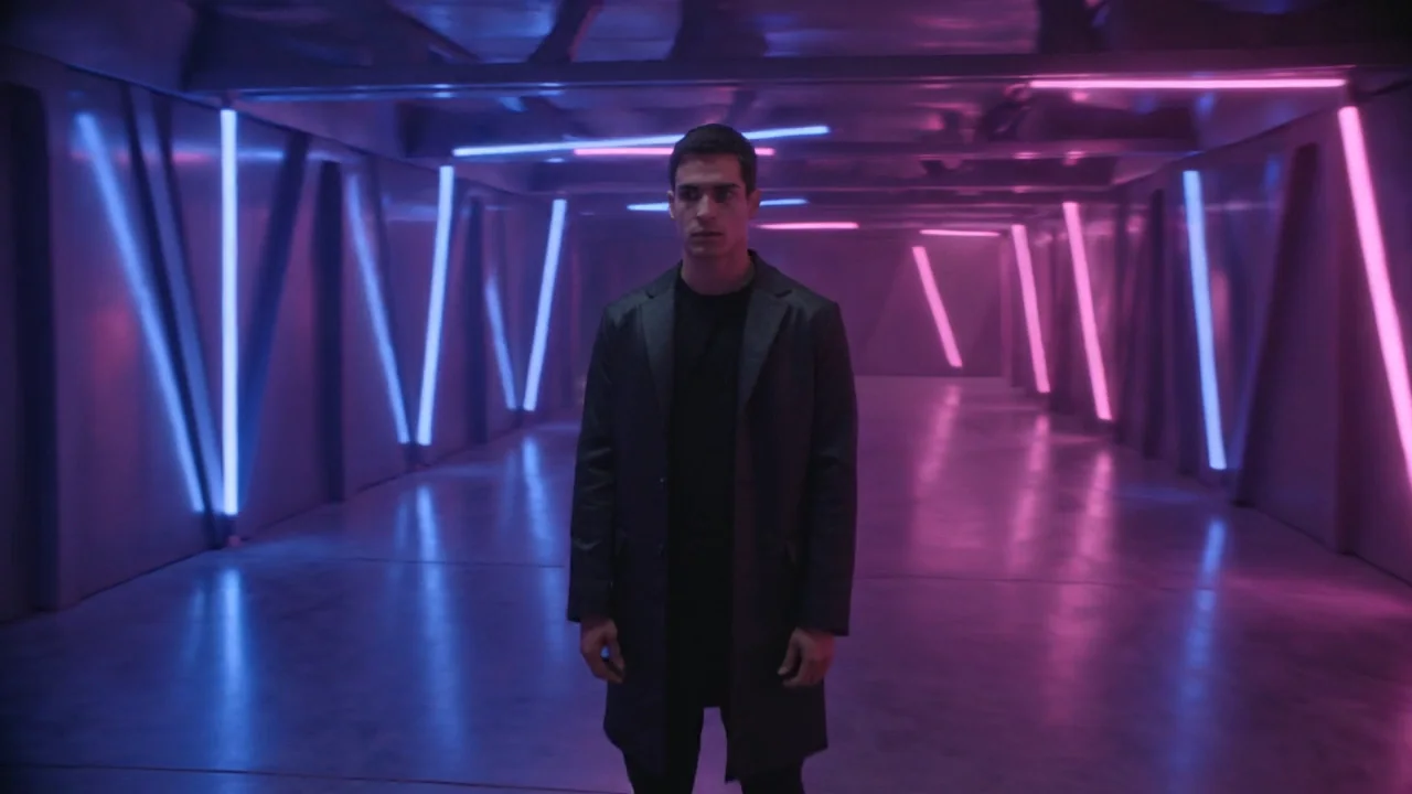 The vague prompt on Kling v3: a man in a dark coat in a corridor of slanted blue and magenta tubes