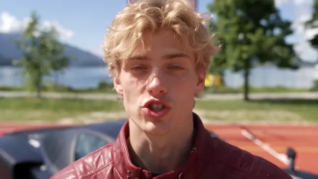 Pull-out reveal: the camera starts on his face and pulls back until the whole court, the car and the lake are in frame