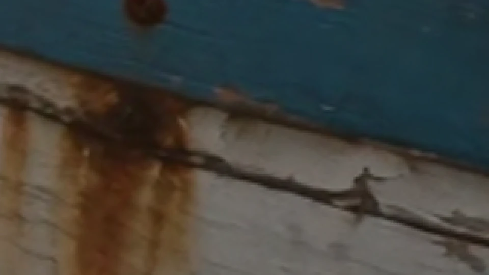The same patch after the whole frame was squeezed to 1080p and stretched back: the cracks and grain are softer.