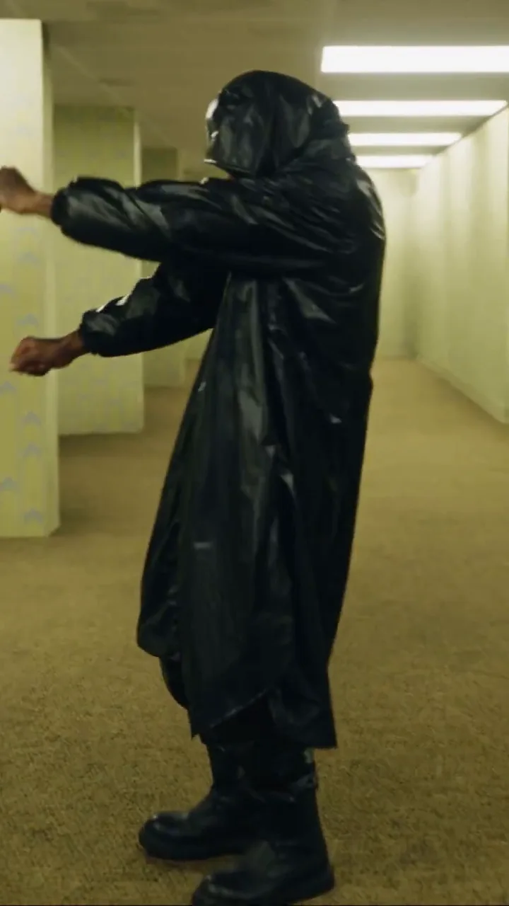 The Miroge render: the black raincoat look doing the same moves in the yellow Backrooms corridors