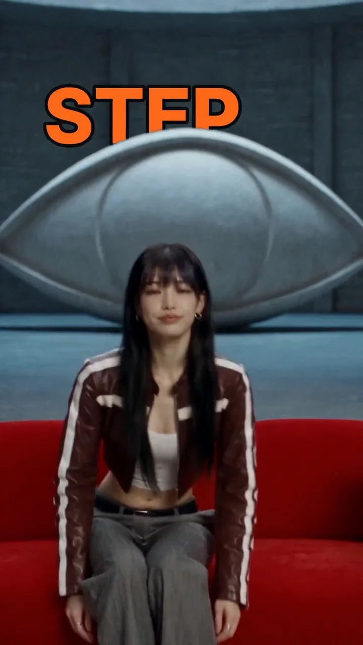 Vera, an AI host with long black hair in a burgundy racing jacket, walking to a red sofa and sitting down, with HERE'S EXACTLY HOW and a big orange STEP tucked behind her head, then a close-up with small captions low over her chin